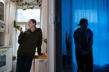 A woman split by light and shadow, symbolizing the internal conflict caused by the Controller Saboteur.